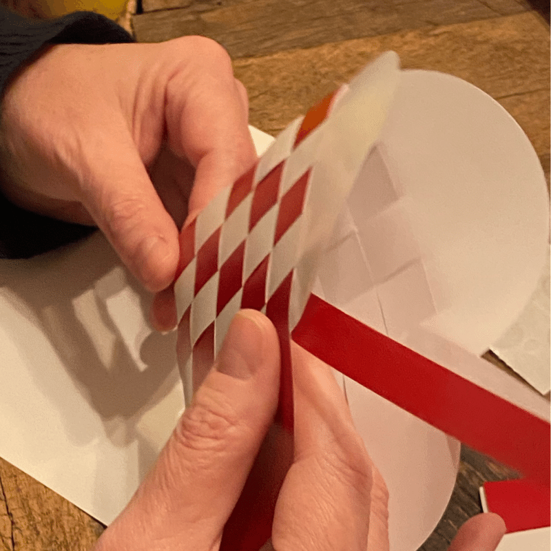 Weaving a traditional Danish paper heart by hand – an authentic handmade souvenir from Copenhagen